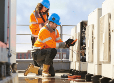 Commercial Services A Photograph of a Male Engineer and a Female Engineer Testing Electrical Signals Using Multimeters